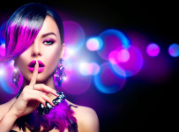 Sexy beauty fashion woman with purple dyed fringe hairstyle isolated on black background